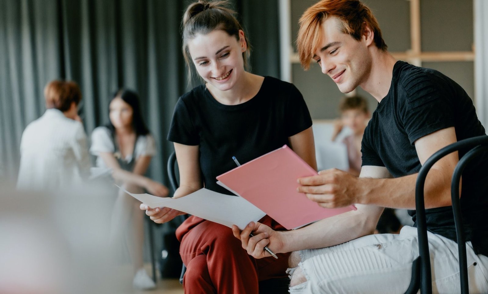 Two people reading a training script together